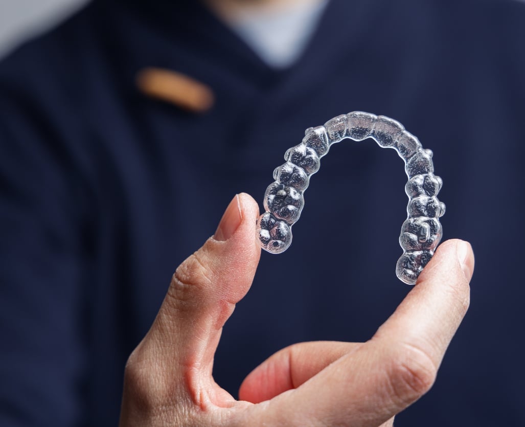 Orthodontist holding Invisalign