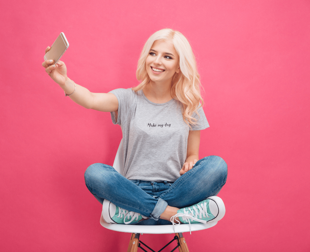 Smiling young woman making selfie photo