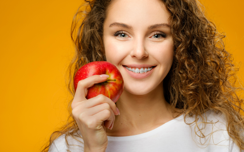 Girl with braces eating apple