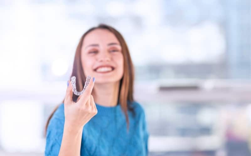 girl holding Invisalign